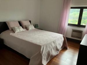 a bedroom with a bed with a white blanket and a window at Sonho No Mondego in Penacova +30 photos