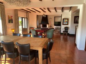 a dining room and living room with a table and chairs at Sonho No Mondego in Penacova
