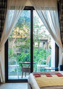 a bedroom with a bed and a large window at 233 Boulevard by QUAO REALTY in Accra