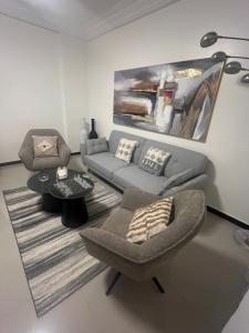 a living room with a couch and a chair at Farid Street - Studio - Dakar Plateau in Dakar
