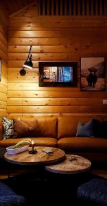 a living room with a couch and a table at Charming Small Cabin At The Top Of Blefjell in Flesberg