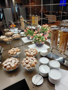 a table topped with bowls and plates of food at Nova Hotel in Radom +36 photos