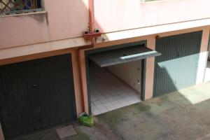 a garage with two green doors and a window at Da Nanni in Villasimius