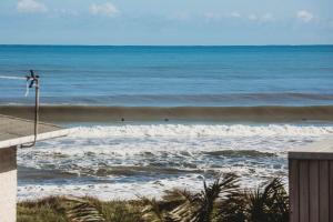 a view of the ocean from a beach at Beach House On Hamblyn in New Plymouth
