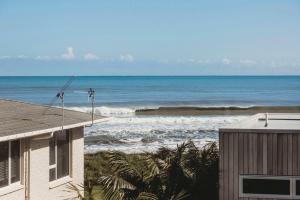 a view of the ocean from the balcony of a house at Beach House On Hamblyn in New Plymouth