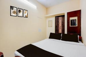 Postel nebo postele na pokoji v ubytování Hotel O Cooum Riverview Chennai Formerly Nimalan Residency + 22 fotografií