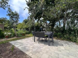 a table and chairs sitting on a patio at Au gré des marées - proche mer in Plérin