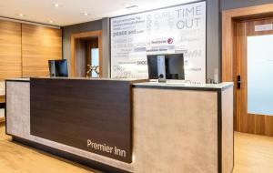 a reception desk in a lobby with a presentation at Premier Inn Passau Weisser Hase in Passau