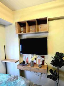 a tv on a wall in a room with at Casa Istilo Studio at Avida Abreeza Davao in Davao City