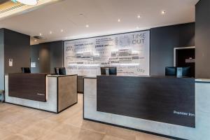 a lobby with a large wall with a large at Premier Inn Essen City Centre in Essen