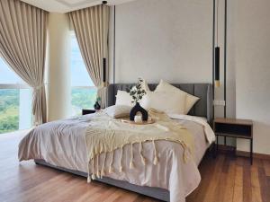 a bedroom with a large bed with a large window at Luxury 4BR Duplex, Medini Apartment in Iskandar Puteri