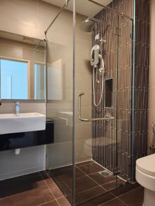 a bathroom with a shower and a sink and a toilet at Luxury 4BR Duplex, Medini Apartment in Iskandar Puteri