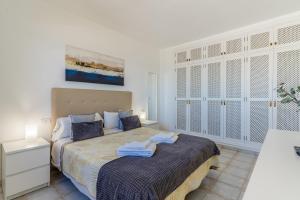 a bedroom with a bed with towels on it at Penthouse with ocean views - Torviscas in Adeje +49 photos