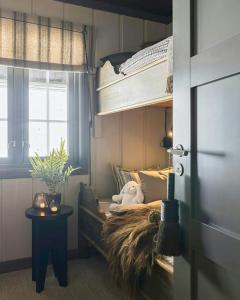 a bedroom with a bunk bed with a teddy bear at Renovated Mountain Cabin With Cross Country Trails in Granheim +15 photos
