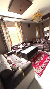 a living room with couches and a couch at Tranquil trails home stay naddi in Dharamshala
