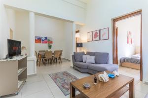 a living room with a couch and a table at Daya 2BR Apartment In Batroun in Batroûn