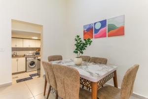 a dining room table with chairs and a plant on it at Daya 2BR Apartment In Batroun in Batroûn +19 photos