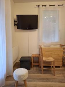 a living room with a flat screen tv on the wall at Petit ours I N10 2P5 in Marcoux