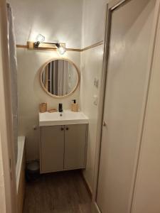 a bathroom with a sink and a mirror at Petit ours I N10 2P5 in Marcoux