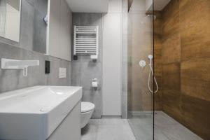 a bathroom with a white sink and a toilet at K52 Apartments in Wrocław +138 photos