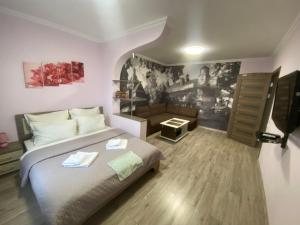 a bedroom with a bed and a couch at Apartment Vid na Krepost in Kamianets-Podilskyi