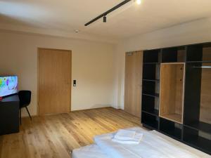 ein leeres Zimmer mit einem Bett und einem Fernseher in der Unterkunft Zum Posthalter in Hemau
