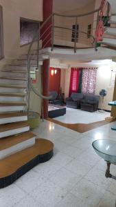 a living room with a spiral staircase in a building at The Nest - Garwa in Miraj +10 photos