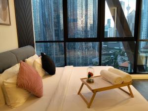 a living room with a white couch and a large window at Scarletz Service Suites KLCC in Kuala Lumpur +116 photos