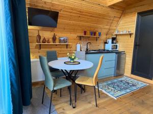 a kitchen with a table and chairs in a room at Welcome Cottage in Kazbegi