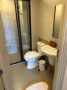 a bathroom with a toilet and a sink and a shower at Dcondo Reef Phuket in Kathu