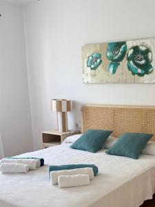 a bedroom with a bed with two towels on it at Villa Truvi in Cala Galdana