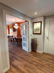 a dining room and living room with a table and chairs at La Elegancia del Centro by Alogest in Zaragoza