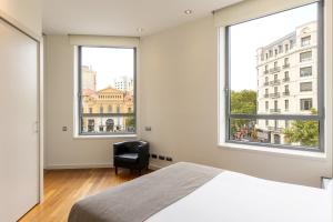Ένα ή περισσότερα κρεβάτια σε δωμάτιο στο Uma Suites Passeig de Gracia 16