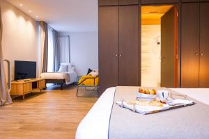 a bedroom with a bed with a tray of fruit on it at Grand Hôtel du Luxembourg & Spa in Bayeux +61 photos