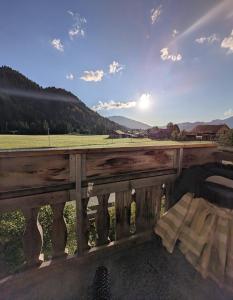 a wooden fence with a view of a field at Hoamatl in Tannheim