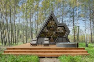a house with two chairs on a wooden deck at Mandra Petrichor in Zabuyanʼye +19 photos