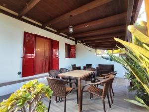 an outdoor patio with a wooden table and chairs at Villa Pizzomunno a Vieste con accesso diretto alla Spiaggia di Pizzomunno in Vieste +84 photos