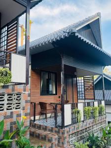 a house with a balcony with a table on it at Real Koh Rong in Koh Rong +26 photos