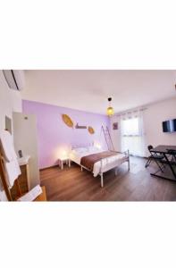 a bedroom with a bed and a table at Éclipse in Vénissieux +9 photos