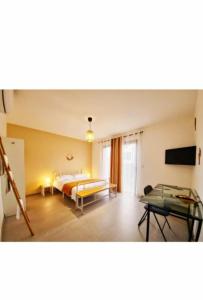 a bedroom with a bed and a table in it at Éclipse in Vénissieux