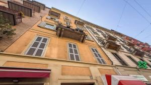 a yellow building with windows andadders on the side of it at AM15 - Design & Relax near the Navigli in Milan