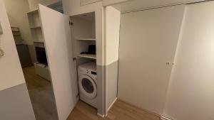 a laundry room with a washer and a washing machine at AM15 - Design & Relax near the Navigli in Milan