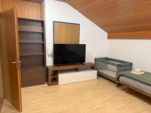 a living room with a flat screen tv on a table at Ferienwohnung Happy Life Thun in Steffisburg