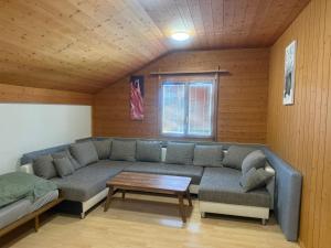 a living room with a couch and a table at Ferienwohnung Happy Life Thun in Steffisburg