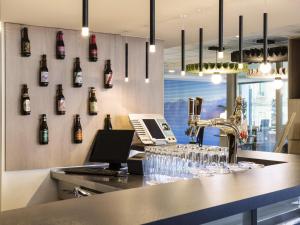 een bar met glazen op een aanrecht in een restaurant bij ibis Lausanne Centre in Lausanne