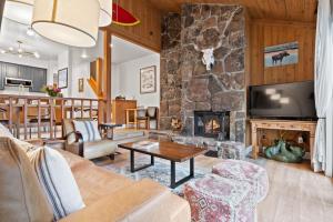 a living room with a couch and a fireplace at RMR: Cinquefoil 1612 Condo in The AspensWilsonWY in Wilson