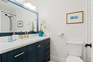 a bathroom with blue cabinets and a sink and a mirror at RMR: Cinquefoil 1612 Condo in The AspensWilsonWY in Wilson +17 photos