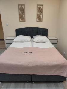 a bed in a room with a large mattress at Willa Maja in Ciechocinek +36 photos