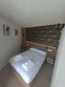 a bedroom with a white bed and a chair at Palm Breeze - Las Americas in Playa de las Americas