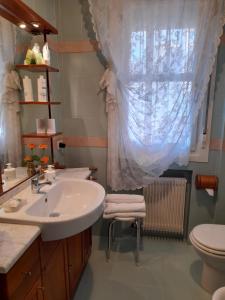 a bathroom with a sink and a toilet and a window at Luxury House B&B in Bassano del Grappa +69 photos